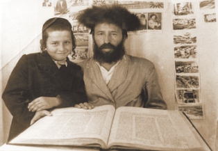 With his father, Reb Shlomo Zalman zt"l, in their sukkah. 