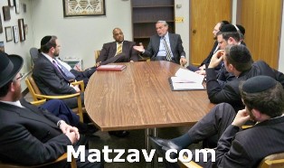 Members of today's Agudath Israel delegation to Albany, conferring with State Senator John L. Sampson.