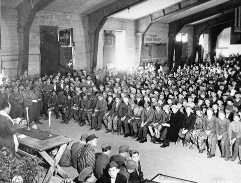Rabbi Hershel Schaecter leading the davening on the first day of Shavuos for Buchenwald survivors shortly after liberation.